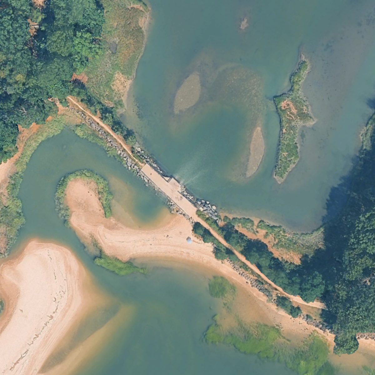 The Sluice from above: the causeway crossing the shallows, the bridge span, and the sand spit